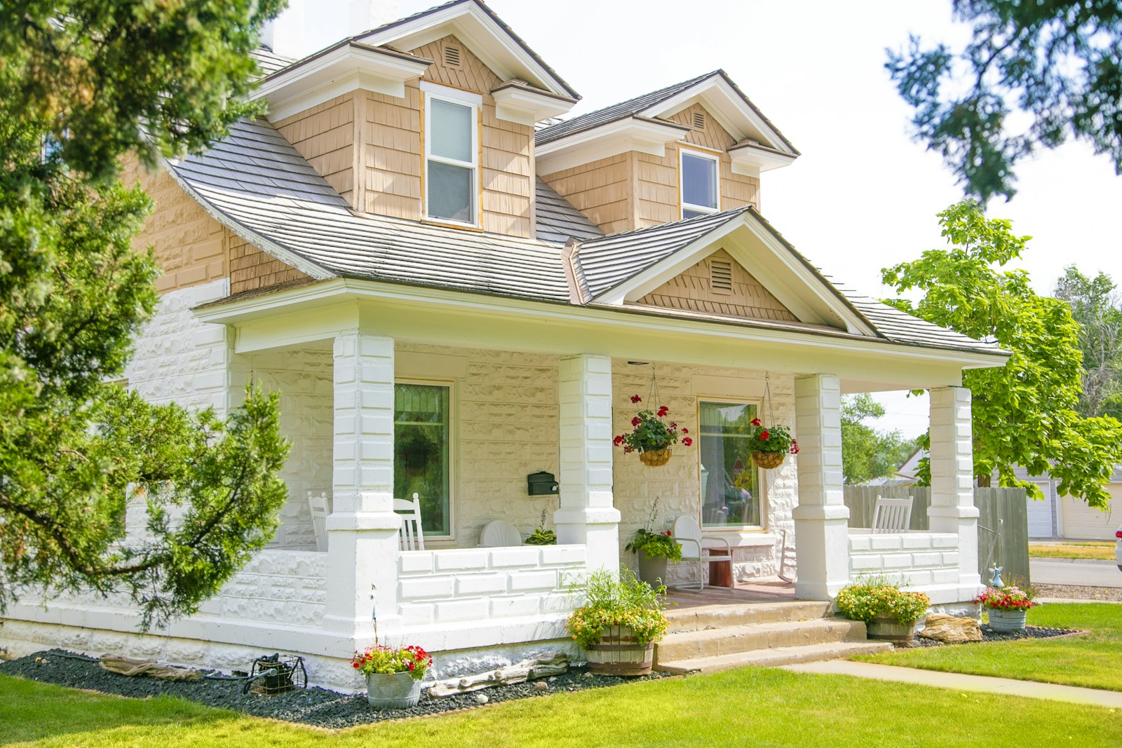 A welcoming craftsman home framed by mature trees